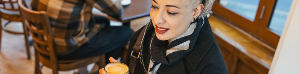 Lady enjoying a coffee inside a coffee shop