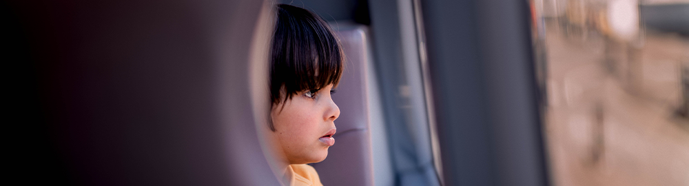 Image of child looking out of bus window